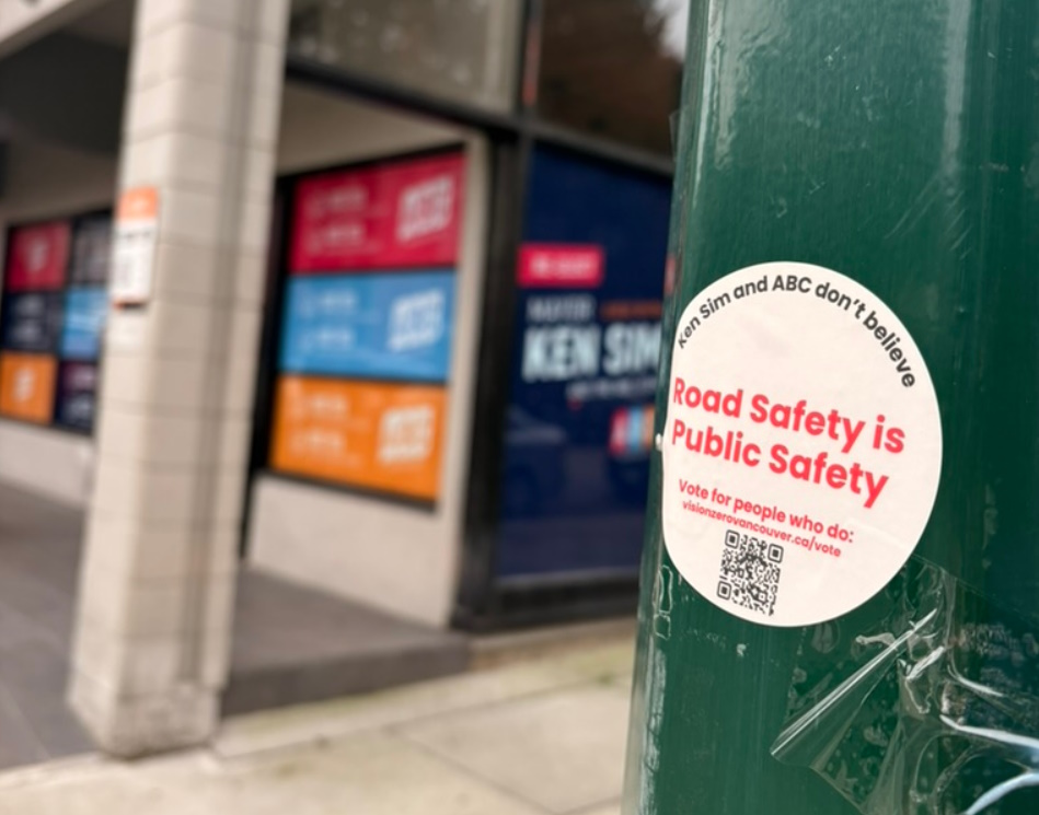 Image of a sticker that says "Ken Sim and ABC don't believe road safety is public safety" in front of ABC headquarters